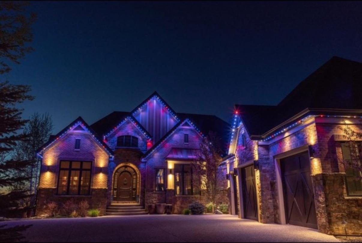 Purple and blue permanent LED lighting on a stone home