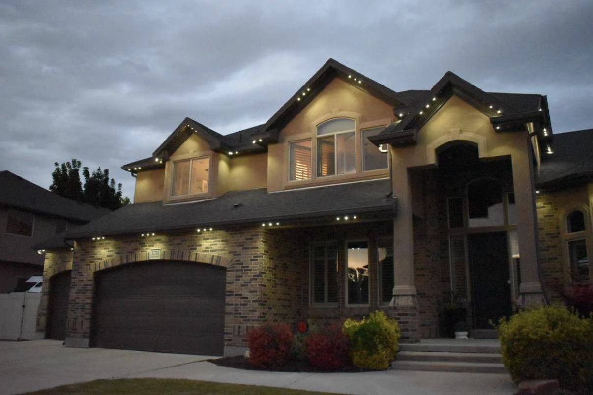 Permanent LED lighting on a craftsman home at dusk